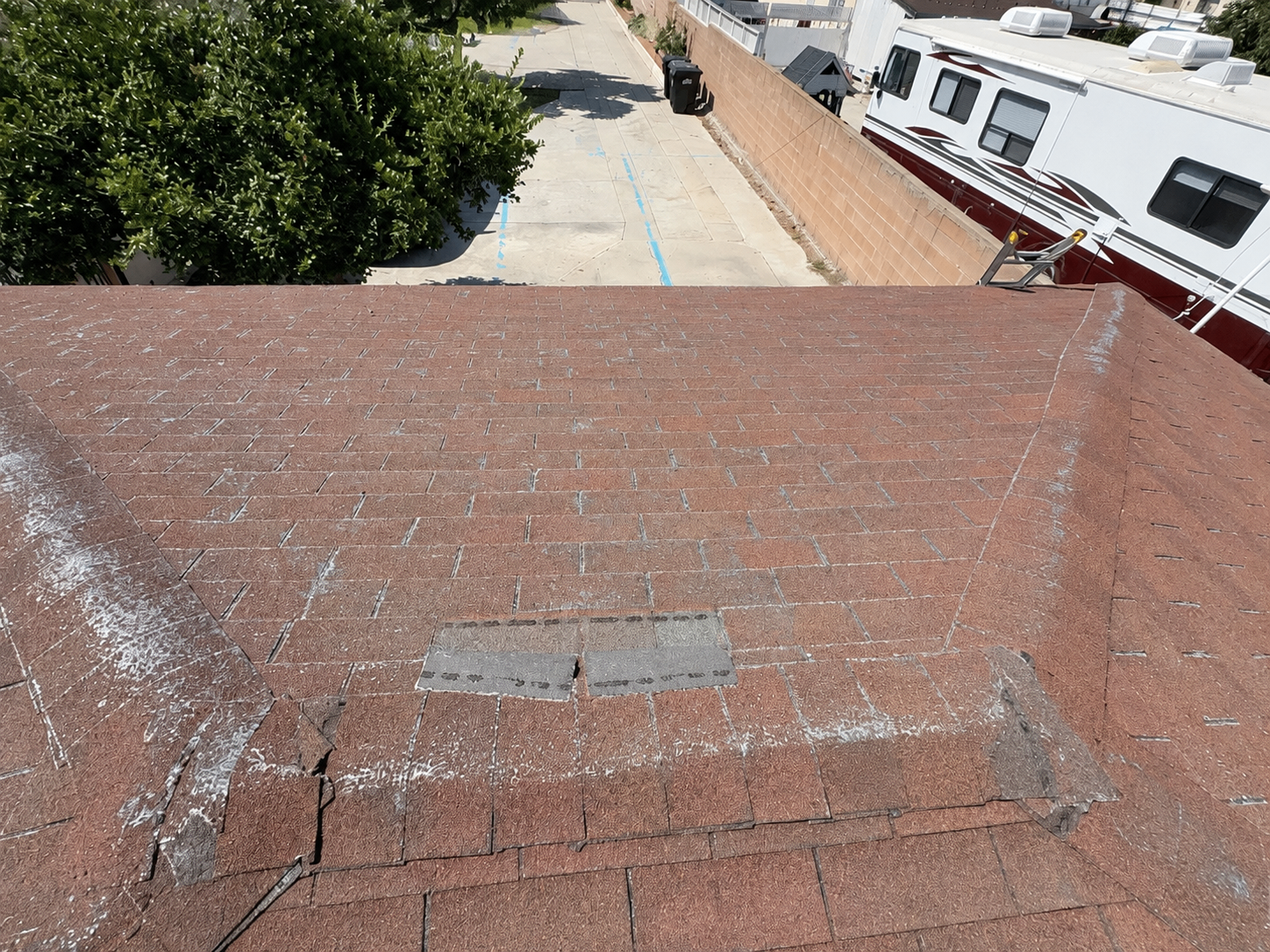 Aging asphalt shingles showing granule loss and dryness on an Orange County home